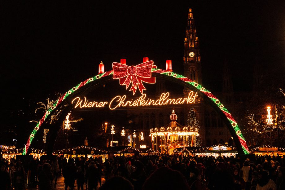 The Christkindlmarkt lit up in front of Vienna's city hall at night